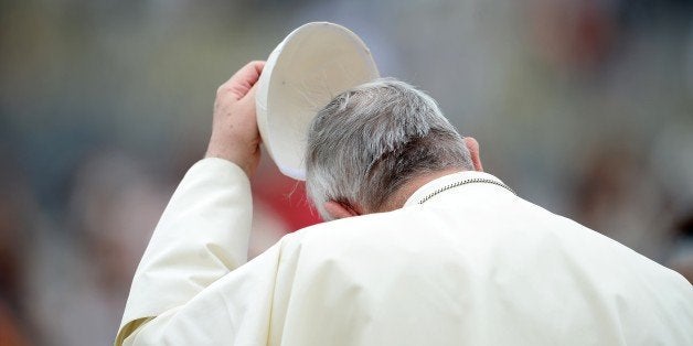 Pope Francis takes off his skullcap during his weekly general audience in St Peter's Square at the Vatican on September 10, 2