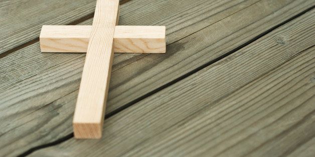 wooden cross on wood background