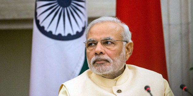 Narendra Modi, India's prime minister, attends a meeting with Xi Jinping, China's president, unseen, to sign a series of agreements between the two nations at Hyderabad House in New Delhi, India, on Thursday, Sept. 18, 2014. Modi won a pledge from Xi to invest $20 billion as the leaders sought to adjust a lopsided trade relationship and resolve a decades-long border dispute. Photographer Graham Crouch/Bloomberg via Getty Images 