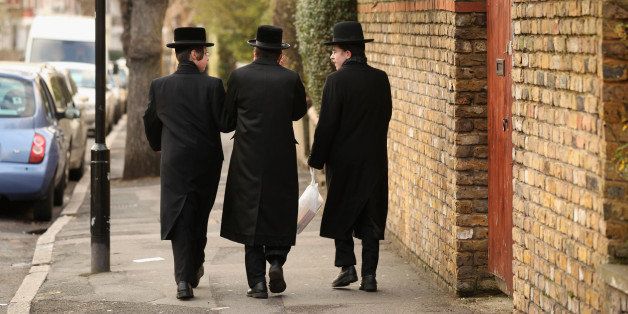 LONDON, ENGLAND - JANUARY 19: Jewish men walk along the street in the Stamford Hill area of north London on January 19, 2011 in London, England. The residents of Stamford Hill are predominately Hasidic Jewish and only New York has a larger community of Hasidic Jews outside Israel. The area contains approximately 50 synagogues and many shops cater specifically for the needs of Orthodox Jews. (Photo by Oli Scarff/Getty Images)