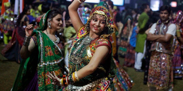 In this Wednesday, Oct. 9, 2013 photo, an Indian woman dressed in traditional finery performs the Garba dance of the Navratri festival in Ahmadabad, India. Dancing the Garba is an important part of celebrations during Navratri, or nine night festival,that began on Oct. 5. (AP Photo/Ajit Solanki)