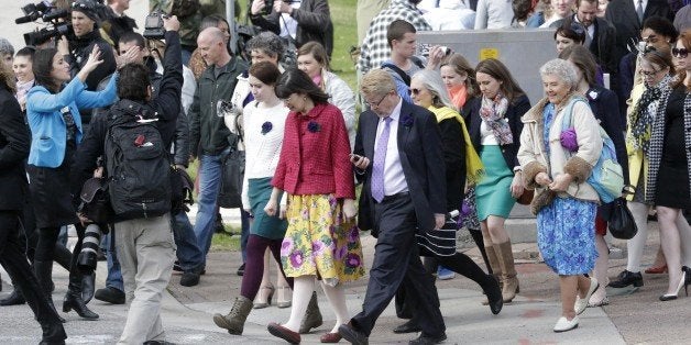 FILE - In this April 5, 2014, file photo, Kate Kelly, center, leads a Mormon's women group pushing the church to allow women