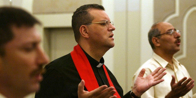 BAGHDAD, IRAQ - JUNE 2: Canon Andrew White (C), the vicar of Baghdad St George's church prays for the release of five British citizens kidnapped earlier this week on June 2, 2007 in Baghdad, Iraq. Canon White appealed for the release of the kidnapped Britons and said he knew them personally. White could not hold the service in the church for security reasons, instead he held the service in the heavily fortified Green Zone area in Baghdad, Iraq. Five British citizens were kidnapped from an Iraqi government building on May 29, 2007. (Photo by Muhannad Fala'ah/Getty Images)