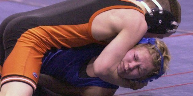 Elaine Blessen, a junior from Malcolm and the first girl to qualify for the Nebraska State Wrestling Tournament, is pinned by Rushville freshman Brett Hunter at 1:59 of the first period Thursday, Feb. 15, 2001, in Lincoln, Neb. The match between two of Class D's top 103-pound wrestlers attracted special attention because Blessen was the only girl among 895 boys at the 73rd annual tournament. (AP Photo/StatePaper.com, Gail Folda)