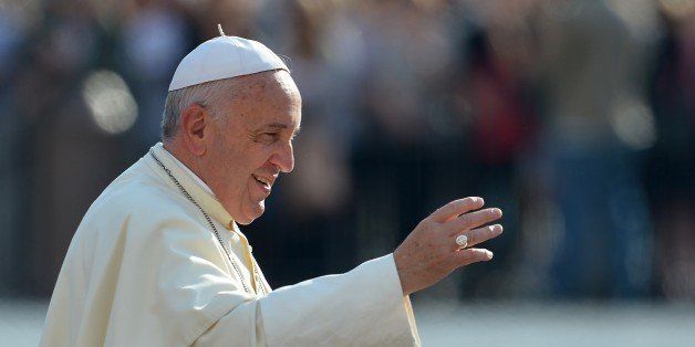 Pope Francis greets the crowd as he arrives for his general audience at St Peter's square on October 1st, 2014 at the Vatican. AFP PHOTO / VINCENZO PINTO (Photo credit should read VINCENZO PINTO/AFP/Getty Images)