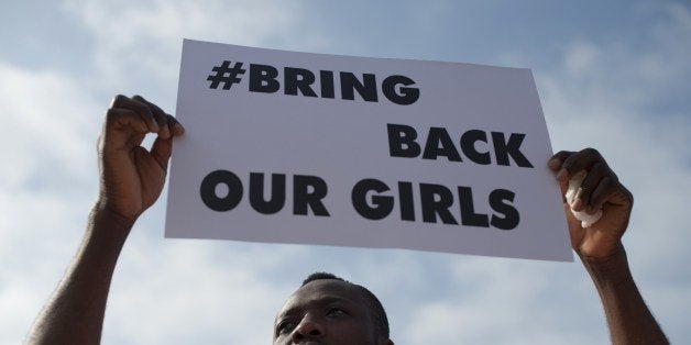 A man holds a placard reading 'Bring Back Our Girls' to denounce the kidnapping of more than 200 Nigerian schoolgirls by Islamic militants on May 13 , 2014 in Malaga. On April 14, 2014, 276 schoolgirls were abducted in the northeastern Nigerian town of Chibook, with eight more seized from Warabe on May 5. The Islamist militant group Boko Haram claimed responsibility, and threatened to 'sell' the girls into slavery. AFP PHOTO / JORGE GUERRERO (Photo credit should read Jorge Guerrero/AFP/Getty Images)