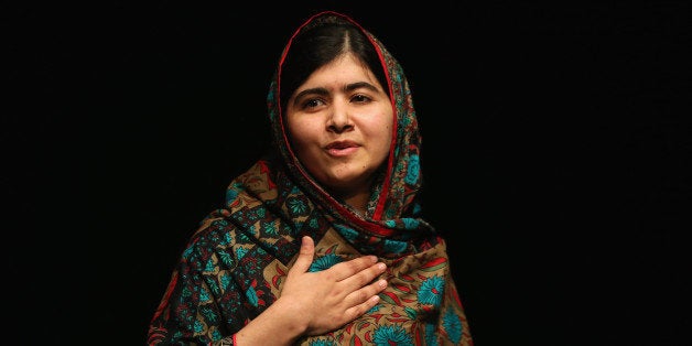 BIRMINGHAM, ENGLAND - OCTOBER 10: Malala Yousafzai acknowledges the crowd at a press conference at the Library of Birmingham