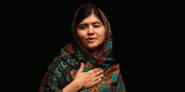 BIRMINGHAM, ENGLAND - OCTOBER 10: Malala Yousafzai acknowledges the crowd at a press conference at the Library of Birmingham after being announced as a recipient of the Nobel Peace Prize, on October 10, 2014 in Birmingham, England. The 17-year-old Pakistani campaigner, who lives in Britain where she received medical treatment following an assassination attempt by the Taliban in 2012, was jointly awarded the Nobel peace prize with Kailash Satyarthi from India. Chair of the Nobel Committee Thorbjorn Jagland made the announcement in Oslo, commending Malala for her Âheroic struggleÂ as a spokesperson for girls' rights to education. (Photo by Christopher Furlong/Getty Images)