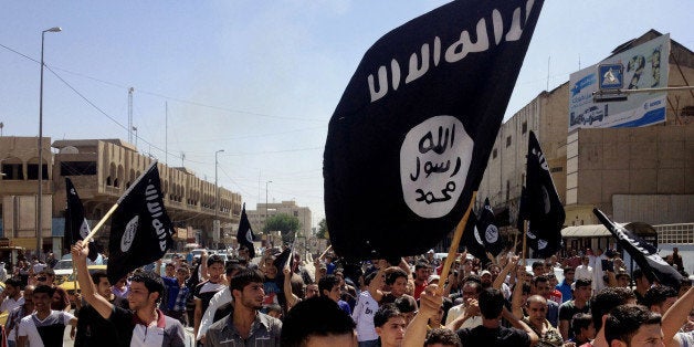 FILE - In this June 16, 2014 file photo, demonstrators chant pro-Islamic State group slogans as they carry the group's flags in front of the provincial government headquarters in Mosul, 225 miles (360 kilometers) northwest of Baghdad. Branding experts say an unfortunate association with a name, like businesses and brands who share the name "Isis" with the notorious Islamic militant group, can scar a companyâs reputation with customers even if the connection is just coincidental. (AP Photo, File)