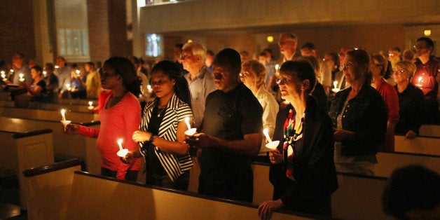 DALLAS, TX - OCTOBER 08: People hold candles during a a prayer vigil and memorial at Wilshire Baptist Church for Thomas Eric Duncan after he passed away from the Ebola virus on October 8, 2014 in Dallas, Texas. Mr. Duncan passed away in the morning. (Photo by Joe Raedle/Getty Images)