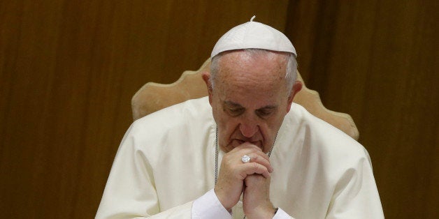 Pope Francis prays as he opens the morning session of a two-week synod on family issues at the Vatican, Saturday, Oct. 18, 20