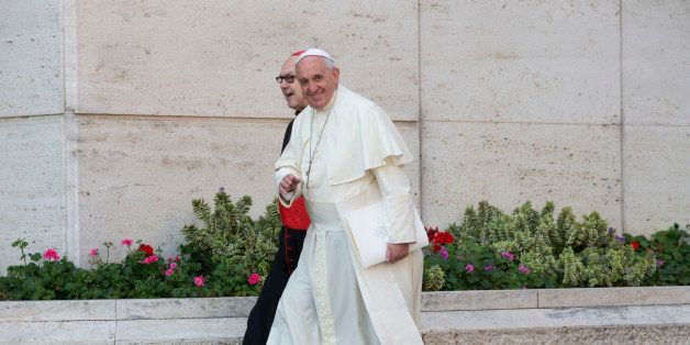Pope Francis, flanked by Cardinal Fernando Sebastian Aguilar, arrives at a morning session of a two-week synod on family issues at the Vatican, Tuesday, Oct. 7, 2014. Francis has urged bishops to speak their minds about contentious issues like contraception, gays, marriage and divorce at the start of the meeting aimed at making the church's teaching on family matters relevant to today's Catholics. (AP Photo/Alessandra Tarantino)