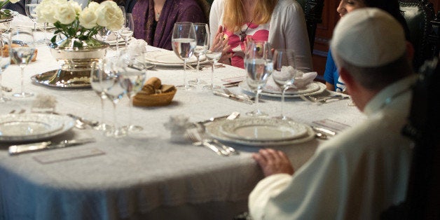 Pope Francis (R) has dinner with a delegation of youngsters at the Saint Joaquim archbishop's Palace in Rio de Janeiro, Brazil, on July 26, 2013. Pope Francis returned to Rome late Sunday after leading a giant beach mass in Brazil for three million pilgrims, ending his historic trip to reignite Catholic passion with pleas for a humbler Church. AFP PHOTO/LUCA ZENNARO/POOL (Photo credit should read LUCA ZENNARO/AFP/Getty Images)