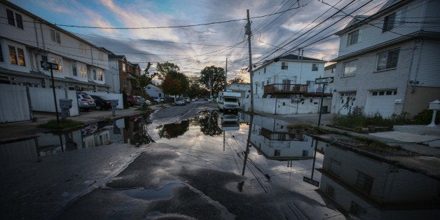 NEW YORK, UNITED STATES - OCTOBER 24: A view of puddle on a street of Staten Island that experienced severe damage and loss of life along with the destruction of many buildings during hurricane Sandy of October 2012 and still bears the trace of disaster with desolate streets and abandoned houses before the upcoming second anniversary of the 'Superstorm Sandy' in Staten Island borough of New York City, United States on October 24, 2014. (Photo by Cem Ozdel/Anadolu Agency/Getty Images)