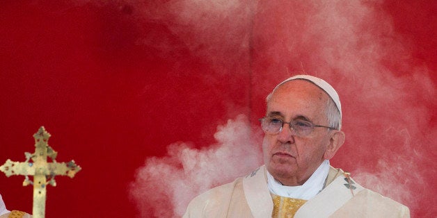 Incense smoke rises in front of Pope Francis as he celebrates a mass at Rome's Verano cemetery, on the occasion of All Saints Day festivity, in Rome, Saturday, Nov. 1, 2014. (AP Photo/Alessandra Tarantino)