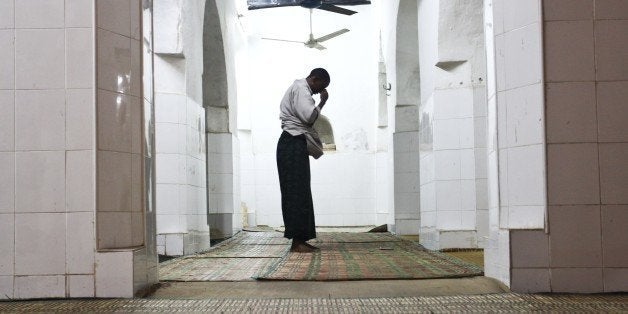 LAMU ISLAND, KENYA FEBRUARY 8: (SOUTH AFRICA OUT) A man is seen during even prayers in one of Lamu Old Town's many beautiful mosques on February 8, 2014 in Lamu Island, Kenya. Lamu has hosted major Muslim religious festivals since the 19th century, and has become a significant center for the study of Islamic and Swahili cultures. Tourist numbers in Kenya have been in decline recently due to heightened security concerns and deteriorating infrastructure. (Photo by Anton Scholtz/The Times/Gallo Images/Getty Images)