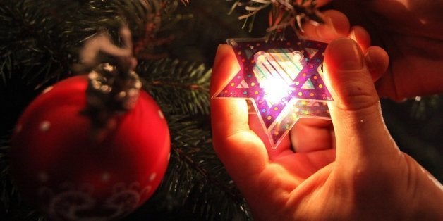 A 'Chrismukkah tree' is decorated with Jewish Christmas decoration in a cafe in Hamburg, northern Germany, on December 21, 2011. According to the director of the Jewish Museum in Berlin, already at the end of the 19th century families celebrated Hanukkah and Christmas together. The term 'Chrismukkah' derives from this occurence. AFP PHOTO / Bodo Marks GERMANY OUT (Photo credit should read Bodo Marks/AFP/Getty Images)