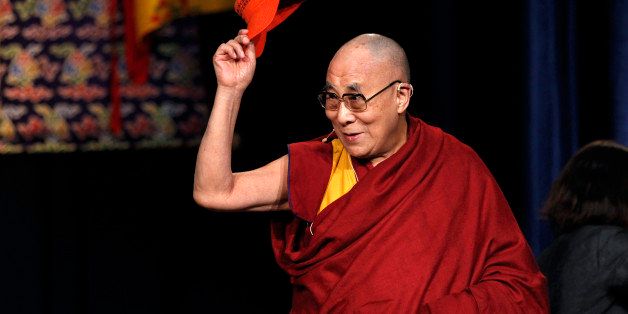 CORRECTS SPELLING OF DALAI LAMA - The Dalai Lama waves a Princeton University cap as he greets a gathering at Princeton University Tuesday, Oct. 28, 2014, in Princeton, N.J. (AP Photo/Mel Evans)