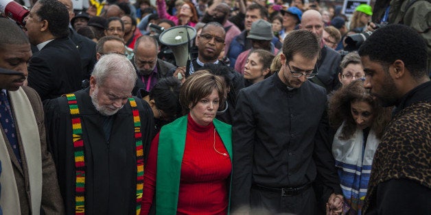 FERGUSON, MO - OCTOBER 13: Clergy members lead hundreds of protestors march from Wellspring Church to the Ferguson police st