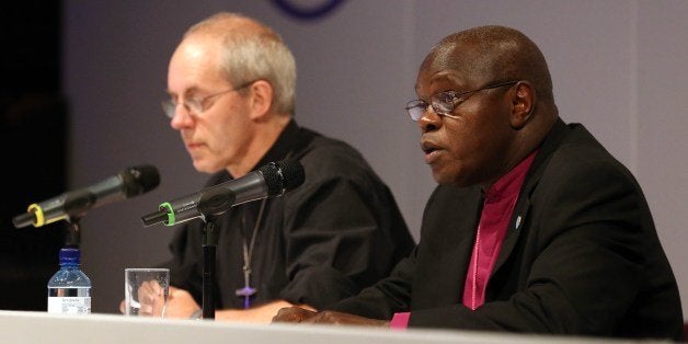 Archbishop of York John Sentamu (R) and Archbishop of Canterbury Justin Welby (L) speak at a press conference after members of the Church of England General Synod voted to allow female bishops in York, northern England, on July 14, 2014. The Church of England overcame bitter divisions on July 14 to vote in favour of allowing female bishops for the first time in its nearly 500-year history. The decision reverses a previous shock rejection in 2012 and comes after intensive diplomacy by Archbishop of Canterbury, Justin Welby. AFP PHOTO / LINDSEY PARNABY (Photo credit should read LINDSEY PARNABY/AFP/Getty Images)