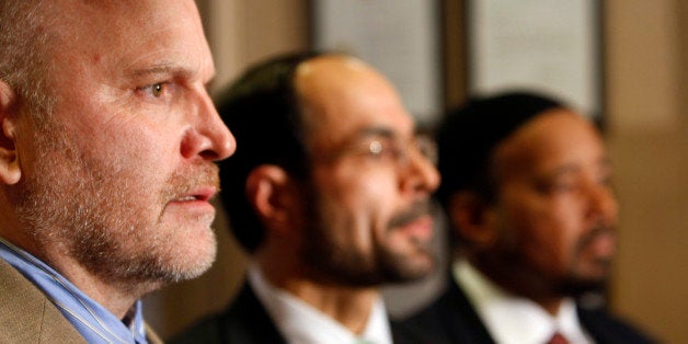 Ibrahim Hooper, left, spokesman for the Council on American-Islamic Relations, speaks at a news conference regarding the arre
