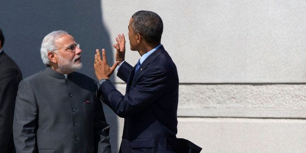 President Barack Obama escorts Indian Prime Minister Narendra Modi at the Martin Luther King Jr. Memorial in Washington, Tuesday, Sept. 30, 2014. President Barack Obama and India's new Prime Minister Narendra Modi said Tuesday that "it is time to set a new agenda" between their countries, addressing concerns that the world's two largest democracies have grown apart. (AP Photo/Evan Vucci)