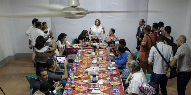 Egyptian Jewish community leader, Magda Haroun, top center, welcomes visitors during its Iftar party, evening meal when Muslims break their fast during the Islamic month of Ramadan, at synagogue Shaar Hashamayim in Cairo, Egypt, Wednesday, July 9, 2014. (AP Photo/Amr Nabil)