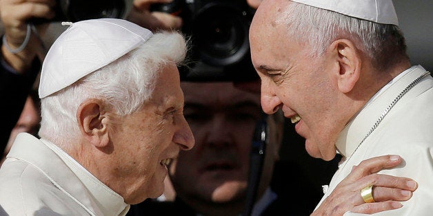 Pope Francis, right, hugs Pope Emeritus Benedict XVI prior to the start of a meeting with elderly faithful in St. Peter's Square at the Vatican, Sunday, Sept. 28, 2014. (AP Photo/Gregorio Borgia)