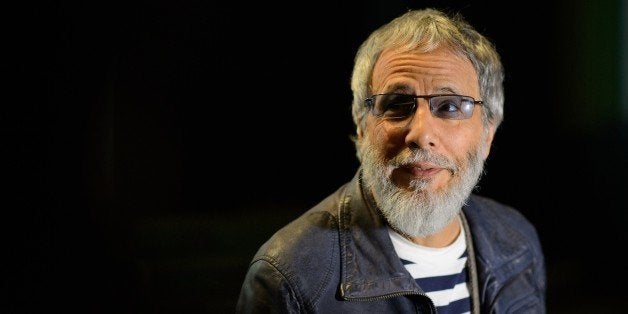 TO GO WITH STORY BY JACQUES KLOPP British singer-songwriter Yusuf Islam, formely known as Cat Stevens, is interviewed at the Hammersmith Apollo in west London on November 5, 2014. Folk-pop legend Cat Stevens has been known as Yusuf Islam since he became a Muslim in the 1970s. After a long absence, he is making his comeback with a world tour that attempts to reconcile his dual identity. AFP PHOTO / LEON NEAL (Photo credit should read LEON NEAL/AFP/Getty Images)
