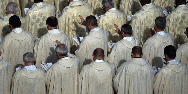 Priests attend a canonization mass for Eufrasia Eluvathingal, friar Francescano Amato Ronconi, bishop Antonio Farina, priest Kuriakose Elias Chavara, friar Francescano Nicola Saggio da Longobardi and friar Francescano Amato Ronconi at St Peter's square on November 23, 2014 at the Vatican. AFP PHOTO / GABRIEL BOUYS (Photo credit should read GABRIEL BOUYS/AFP/Getty Images)