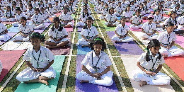 Indian students of Delhi Public School perform yoga in Hyderabad on October 20, 2014. Nearly 5000 students including teachers perform seven yogic postures, with religious prayers for world harmony and peace. AFP PHOTO / Noah SEELAM (Photo credit should read NOAH SEELAM/AFP/Getty Images)