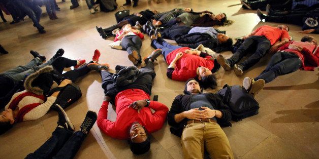 NEW YORK - DECEMBER 3: Demonstrators lie down during a protest in Grand Central Terminal December 3, 2014 in New York. Protests began after a Grand Jury decided to not indict officer Daniel Pantaleo. Eric Garner died after being put in a chokehold by Pantaleo on July 17, 2014. Pantaleo had suspected Garner of selling untaxed cigarettes. (Photo by Yana Paskova/Getty Images)