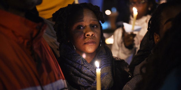 WASHINGTON, DC - NOVEMBER 23: Dana Hall, center, holds a candle during a vigil along Martin Luther King Jr. Ave. SE as people gathered to remember the life of, Marion Barry, a former mayor of Washington, DC on Sunday November 23, 2014 in Washington, DC. (Photo by Matt McClain/ The Washington Post via Getty Images)