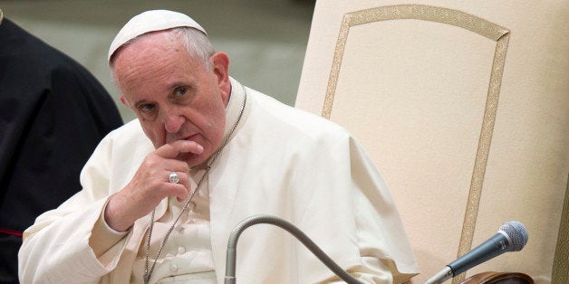 Pope Francis listens to a speech during a special audience he held for members of the FOCSIV Italian Catholic volunteers, at the Vatican, Thursday, Dec. 4, 2014. (AP Photo/Andrew Medichini)