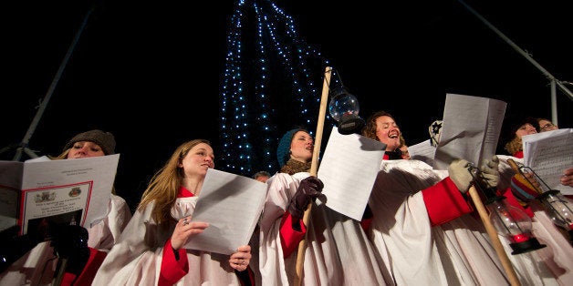 A choir sings christmas carols during the official ceremony to turn on the Christmas tree lights in Trafalgar Square, central