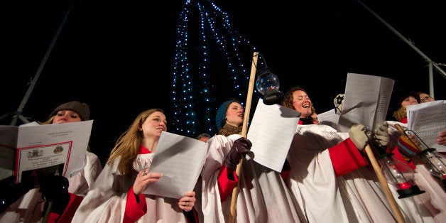 A choir sings christmas carols during the official ceremony to turn on the Christmas tree lights in Trafalgar Square, central London, on December 6, 2012. The annual Christmas Tree in Trafalgar Square is a present from the Norwegian capital of Oslo to the citizens of London, given as a gift for over 60 years as a token of gratitude for Britain's support during the Second World War. AFP PHOTO/ANDREW COWIE (Photo credit should read ANDREW COWIE/AFP/Getty Images)