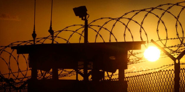 In this photo reviewed by the U.S. military, the sun rises above Camp Delta at Guantanamo Bay Naval Base, Cuba, Wednesday, Nov. 20, 2013. During nearly 12 years of legal disputes and political battles, the United States has put off deciding the fate of al-Qaida and Taliban militants held at Guantanamo Bay, captured after the Sept. 11 attacks but denied quick or full access to the American justice system. (AP Photo/Charles Dharapak)