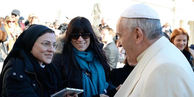 In this photo provided by the Vatican newspaper L' Osservatore Romano, Pope Francis greets Sister Cristina Scuccia as she presents him with her compact disk at the end of his weekly general audience in St. Peter's Square at the Vatican, Wednesday, Dec. 10, 2014. After winning the Voice of Italy singing contest, the Ursuline nun launched her first album "Sister Cristina" last month, after a single also included in the album, with her version of Madonna's "Like a Virgin". (AP Photo/L'Osservatore Romano, ho)