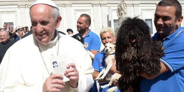 Pope Francis meets members of a Canine unit at the end of his weekly general audience in St Peter's square at the Vatican on September 18, 2013. AFP PHOTO / OSSERVATORE ROMANO == RESTRICTED TO EDITORIAL USE - MANDATORY CREDIT 'AFP PHOTO / OSSERVATORE ROMANO' - NO MARKETING NO ADVERTISING CAMPAIGNS - DISTRIBUTED AS A SERVICE TO CLIENTS == (Photo credit should read OSSERVATORE ROMANO/AFP/Getty Images)