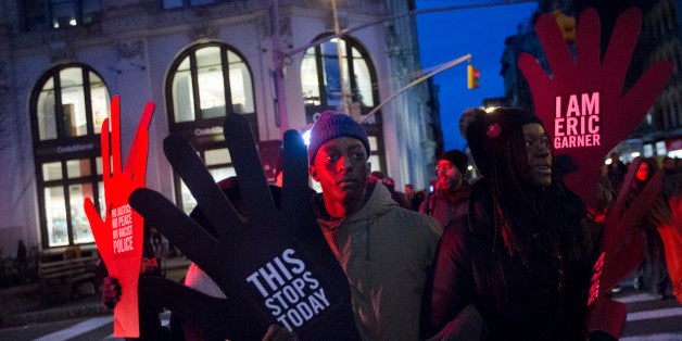 Demonstrators march in New York, Saturday, Dec. 13, 2014, during the Justice for All rally and march. In the past three weeks, grand juries have decided not to indict officers in the chokehold death of Eric Garner in New York and the fatal shooting of Michael Brown in Ferguson, Mo. The decisions have unleashed demonstrations and questions about police conduct and whether local prosecutors are the best choice for investigating police. (AP Photo/John Minchillo)