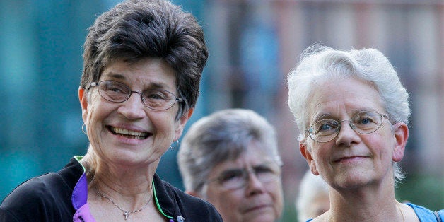 In this Aug. 9, 2012 photo, out going President of The Leadership Conference of Women Religious Sister Pat Farrell, left, and president elect Sister Florence Deacon, right, participates in a vigil with supporters in St. Louis. The largest U.S. group for Roman Catholic nuns meet to decide how they should respond to a Vatican rebuke and order for reform. The LCWR, represents most of the 57,000 American nuns. (AP Photo/Seth Perlman)