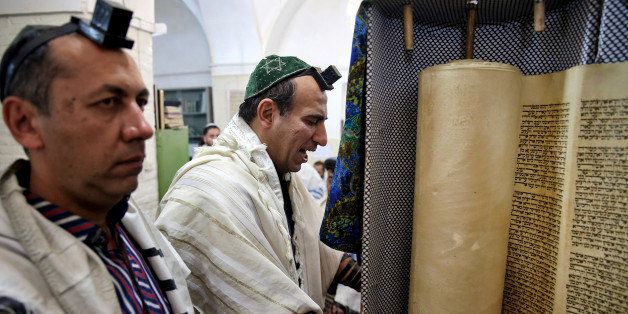 In this Thursday, Nov. 20, 2014 photo, an Iranian Jewish man leads prayers at the Molla Agha Baba Synagogue, in the city of Yazd 420 miles (676 kilometers) south of capital Tehran, Iran. More than a thousand people trekked across Iran this past week to visit a shrine in this ancient Persian city, a pilgrimages like many others in the Islamic Republic until you notice men there wearing yarmulkes. (AP Photo/Ebrahim Noroozi)