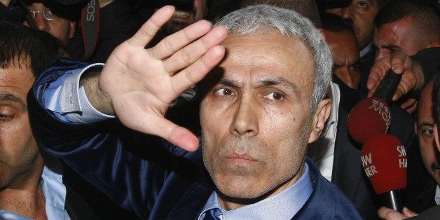 Turk Mehmet Ali Agca, 52, who attempted to kill pope John Paul II on May 13, 1981, raises his hand on January 18, 2010 in Ankara after being freed from prison after almost three decades behind bars. Agca was a 23-year-old militant of the notorious far-right Grey Wolves, on the run from Turkish justice facing murder charges, when he resurfaced in Saint Peter's Square on May 13, 1981, and fired on the pope driving by in an open vehicle. John Paul II was seriously wounded in the abdomen and Agca spent the next 19 years in Italian prisons. AFP PHOTO / ADEM ALTAN (Photo credit should read ADEM ALTAN/AFP/Getty Images)
