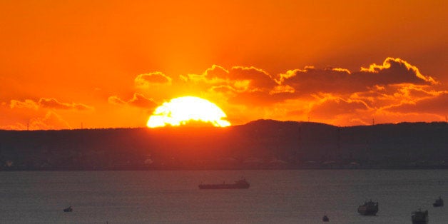 Picture shows the sunrise on New Year's Day over Tokyo Bay on January 1, 2011. AFP PHOTO/KAZUHIRO NOGI (Photo credit should read KAZUHIRO NOGI/AFP/Getty Images)