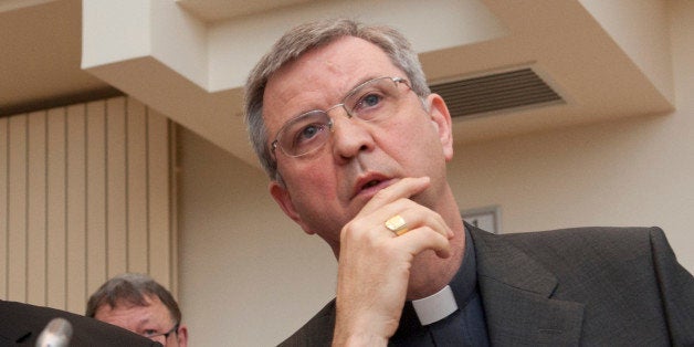 Belgian priests Guy Harpigny (L) and Johan Bonny, who sit on a Belgian Catholic Church monitoring committee on sexual abuse listen on December 14, 2011 in Brussels to the result of work on an arbitration agreement to pay compensation of 2,500 to 25,000 euros to victims of sexual crimes, whose statute of limitations, the legal period within which a crime can be punished, had expired. The Belgian Catholic Church was last year rocked by revelations of nearly 500 cases of abuse by priests since the 1950s, including 13 known suicides among victims. AFP PHOTO / JOHANNA GERON - BELGIUM OUT - (Photo credit should read JOHANNA GERON/AFP/Getty Images)