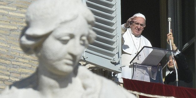 Pope Francis greets the crowd from the window of the Apostolic Palace overlooking St.Peter's square during his Angelus prayer