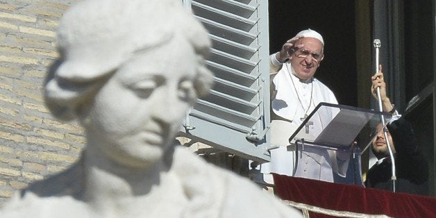 Pope Francis greets the crowd from the window of the Apostolic Palace overlooking St.Peter's square during his Angelus prayer on January 1, 2015 at the Vatican. AFP PHOTO / ANDREAS SOLARO (Photo credit should read ANDREAS SOLARO/AFP/Getty Images)