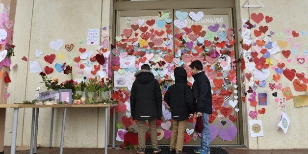 Boys read messages put up on the entrance to a mosque in Uppsala by neighbors pledging their support on January 2, 2015. The mosque suffered a firebomb attack on January 1, one of three arson attacks targeting the muslim community in Sweden since Christmas Day. AFP PHOTO / TT NEWS AGENCY / ANDERS WIKLUND +++SWEDEN OUT (Photo credit should read ANDERS WIKLUND/AFP/Getty Images)