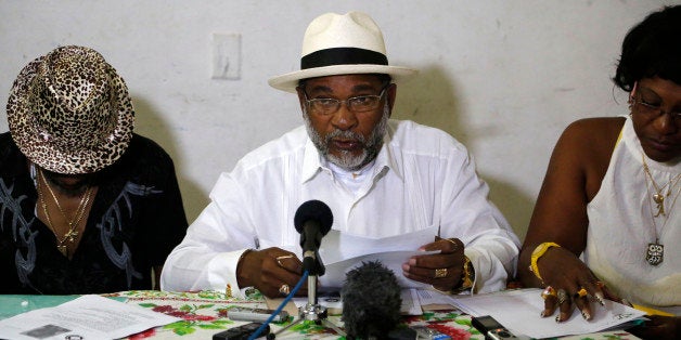 Afro-Cuban Santeria priest Lazaro Cuesta reads predictions for 2015 in Havana, Cuba, Saturday, Jan. 3, 2015. Cuesta, one of the founders of the Commission of the Letter of the Year, said the planned restoration of ties, announced on Dec. 17, with the U.S. opens a period "of hope for all the world." The annual Letter is released each year around New Year's Day. (AP Photo/Desmond Boylan)