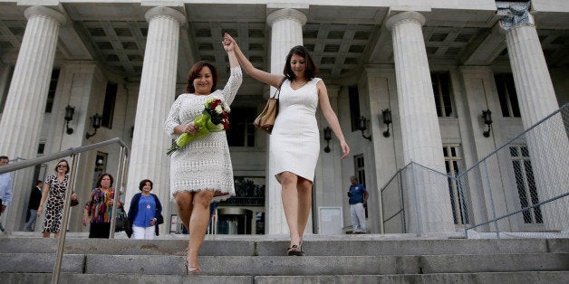 MIAMI, FL - JANUARY 05: Newlyweds Karla Arguello (L) and Catherina Pareto walk out of the Miami-Dade courthouse as the first couple to marry in Florida after Circuit Judge Sarah Zabel presided over the marriage of the couple during a ceremony in the judges courtroom on January 5, 2015 in Miami, Florida. Gay marriage is now legal statewide after the courts ruled that the ban on gay marriage is unconstitutional and the Supreme Court declined to intervene.(Photo by Joe Raedle/Getty Images)